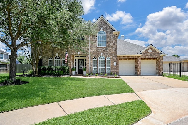 20803 Twisted Leaf Dr, Cypress, TX 77433 - view of front of property with brick siding, an attached garage, driveway, and roof with shingles