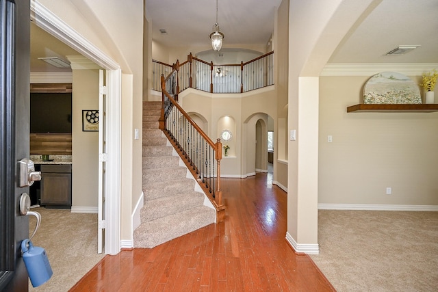20803 Twisted Leaf Dr, Cypress, TX 77433 - entryway featuring arched walkways, stairway, wood finished floors, and crown molding