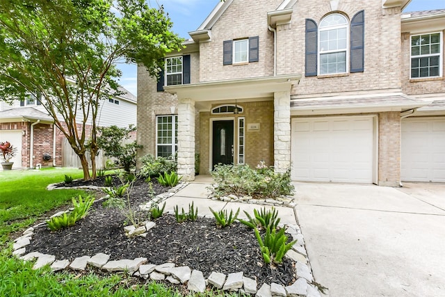 2231 Water Way, Seabrook, TX 77586 - view of front of home with an attached garage, concrete driveway, brick siding, and a front yard