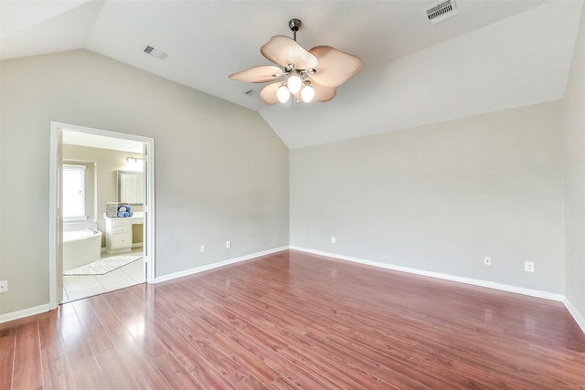 2231 Water Way, Seabrook, TX 77586 - unfurnished bedroom with lofted ceiling, wood finished floors, a ceiling fan, and connected bathroom