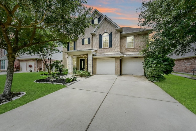 2231 Water Way, Seabrook, TX 77586 - traditional-style house with concrete driveway, brick siding, a front lawn, and a garage