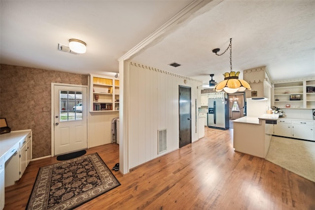 2709 Cherry Ln, Pasadena, TX 77502 - kitchen featuring stainless steel fridge with ice dispenser, light wood-style floors, light countertops, open shelves, and decorative light fixtures