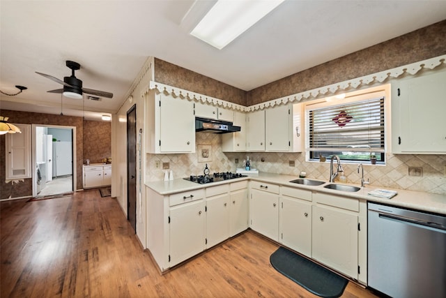 2709 Cherry Ln, Pasadena, TX 77502 - kitchen featuring dishwasher, black stovetop, under cabinet range hood, light wood-style flooring, and light countertops