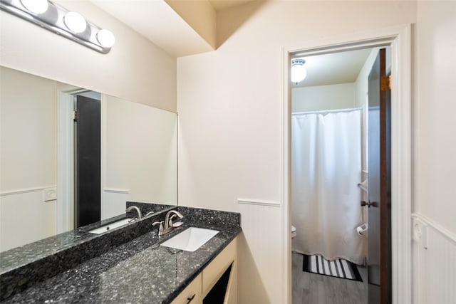 2709 Cherry Ln, Pasadena, TX 77502 - bathroom with toilet, wainscoting, vanity, and wood finished floors
