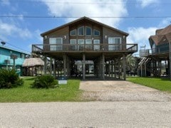 307 Anchor Dr, Freeport, TX 77541 - coastal inspired home with a carport and concrete driveway