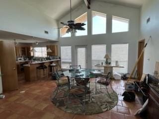 307 Anchor Dr, Freeport, TX 77541 - dining room featuring ceiling fan, beamed ceiling, and high vaulted ceiling
