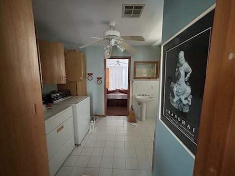307 Anchor Dr, Freeport, TX 77541 - laundry room with washing machine and clothes dryer, cabinet space, and a ceiling fan