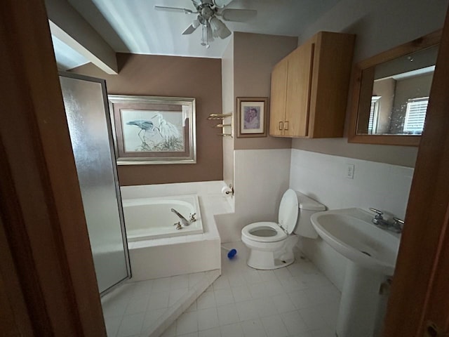 307 Anchor Dr, Freeport, TX 77541 - bathroom with a bath, ceiling fan, toilet, and tile patterned flooring