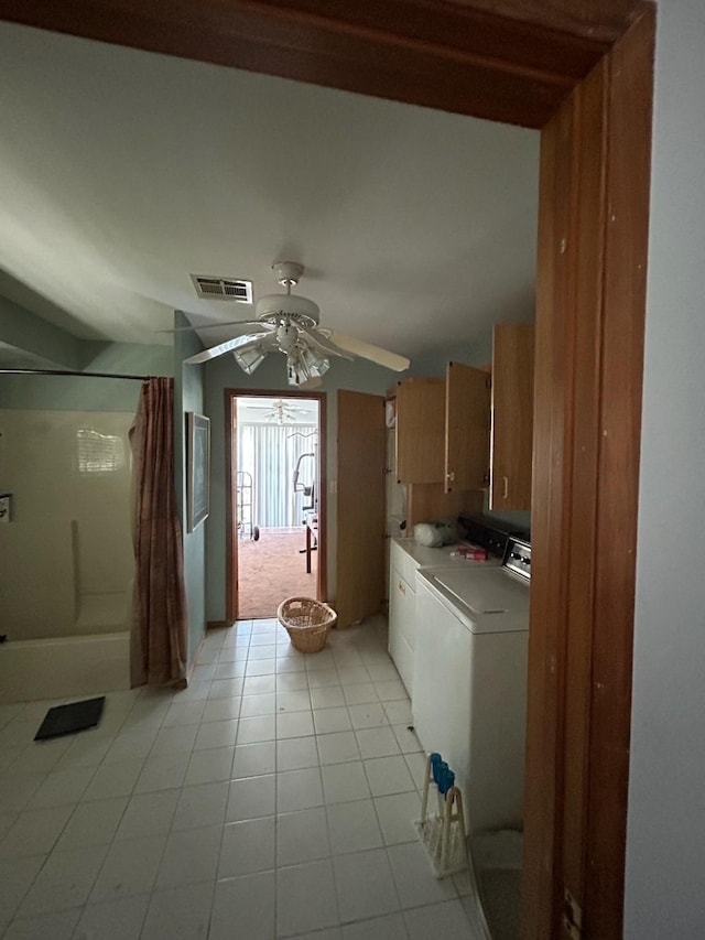 307 Anchor Dr, Freeport, TX 77541 - washroom with washing machine and dryer, a ceiling fan, cabinet space, and light tile patterned floors