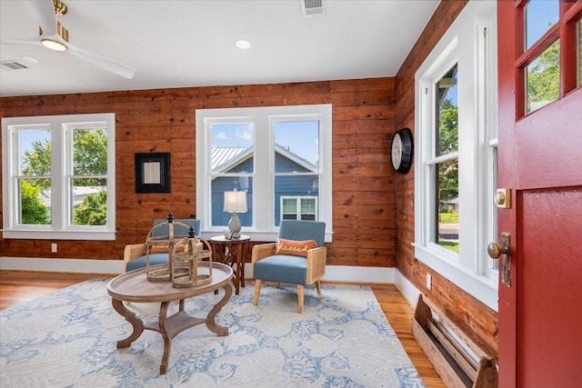 1604 S Austin St, Brenham, TX 77833 - living area featuring baseboards, light wood-style flooring, ceiling fan, wood walls, and recessed lighting