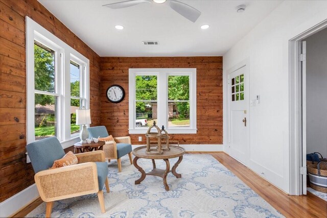 1604 S Austin St, Brenham, TX 77833 - living area featuring light wood-style flooring, ceiling fan, baseboards, recessed lighting, and wood walls
