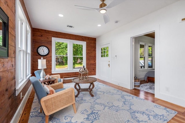 1604 S Austin St, Brenham, TX 77833 - living room featuring wood finished floors, a ceiling fan, recessed lighting, wood walls, and baseboards