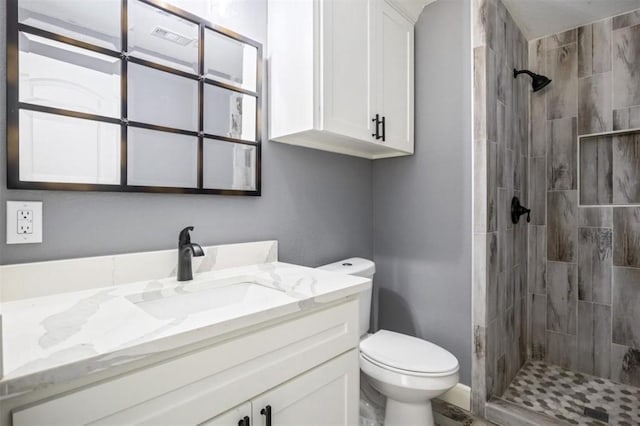 148 Wagon Pass Dr, Huntsville, TX 77340 - bathroom with toilet, vanity, and tiled shower
