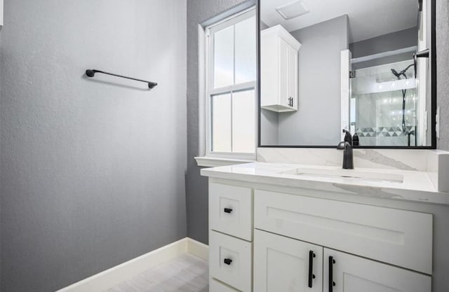 148 Wagon Pass Dr, Huntsville, TX 77340 - bathroom with vanity, a stall shower, and baseboards
