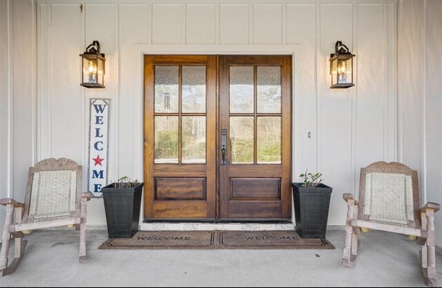 148 Wagon Pass Dr, Huntsville, TX 77340 - property entrance featuring board and batten siding, french doors, and a porch