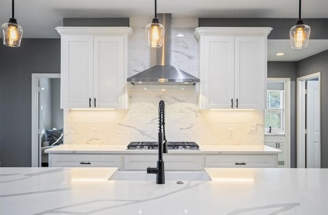148 Wagon Pass Dr, Huntsville, TX 77340 - kitchen with wall chimney range hood, white cabinetry, and decorative backsplash