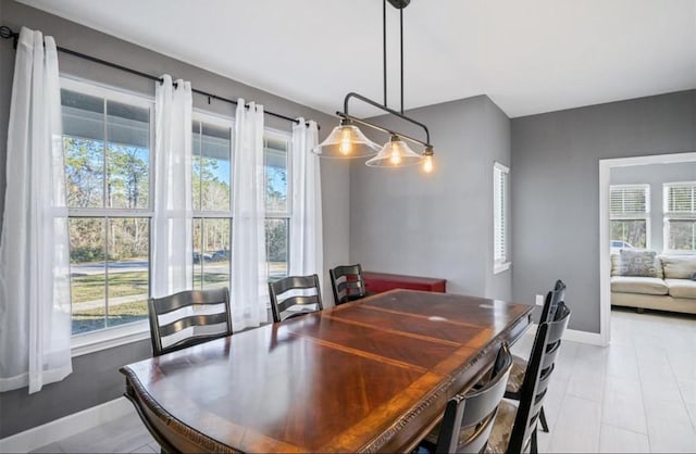 148 Wagon Pass Dr, Huntsville, TX 77340 - dining space featuring healthy amount of natural light, baseboards, and light tile patterned floors