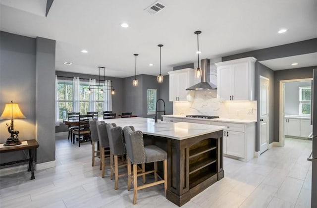 148 Wagon Pass Dr, Huntsville, TX 77340 - kitchen featuring wall chimney exhaust hood, plenty of natural light, tasteful backsplash, a sink, and recessed lighting