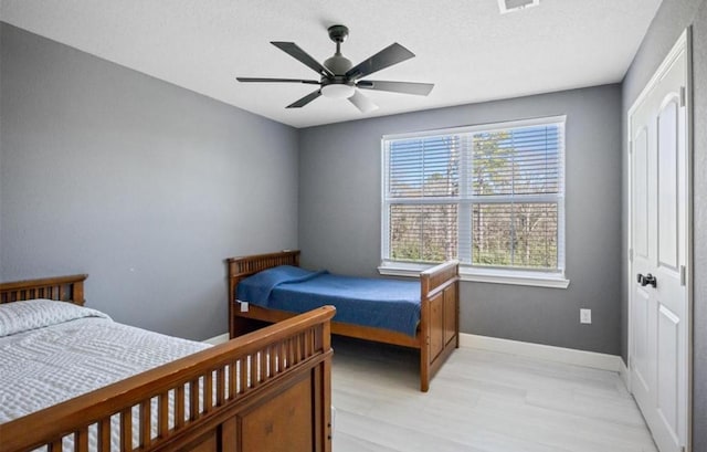 148 Wagon Pass Dr, Huntsville, TX 77340 - bedroom featuring light wood-style floors, baseboards, ceiling fan, and a closet