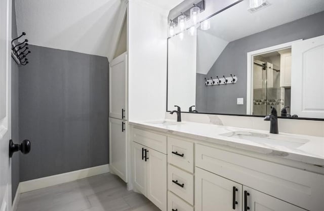 148 Wagon Pass Dr, Huntsville, TX 77340 - bathroom with double vanity, a shower with door, baseboards, and vaulted ceiling