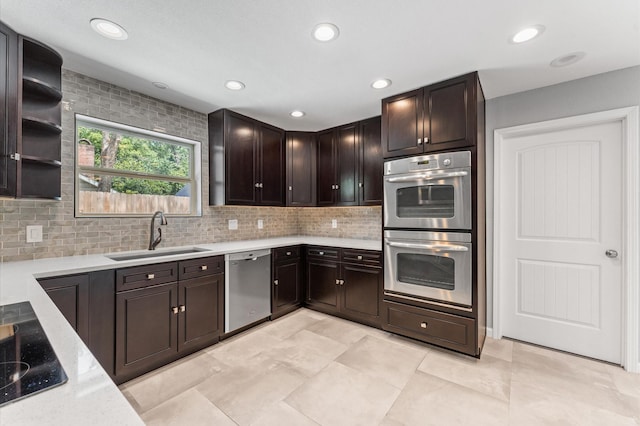 10714 Deerwood Rd, Houston, TX 77042 - kitchen with stainless steel appliances, decorative backsplash, dark brown cabinets, and recessed lighting