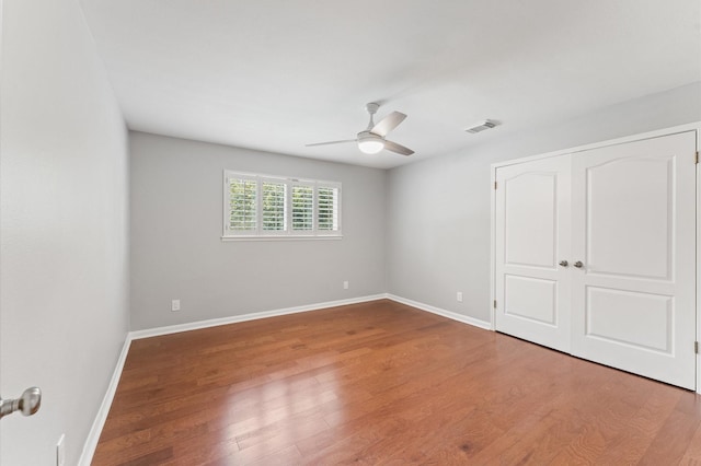 10714 Deerwood Rd, Houston, TX 77042 - unfurnished bedroom with wood finished floors, a ceiling fan, and a closet