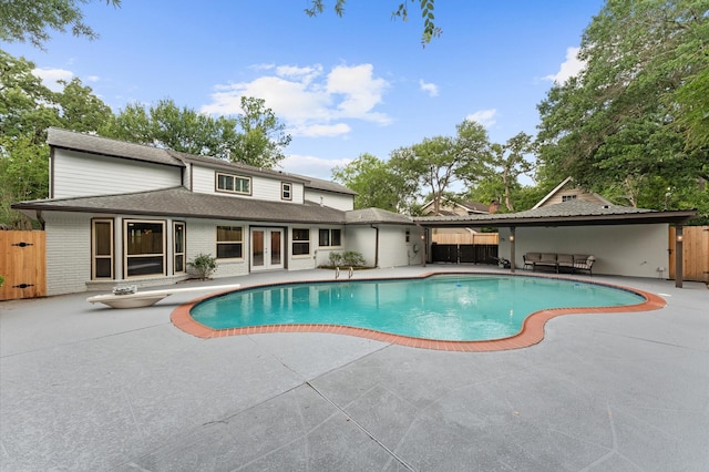 10714 Deerwood Rd, Houston, TX 77042 - view of swimming pool featuring french doors, a patio area, and a diving board