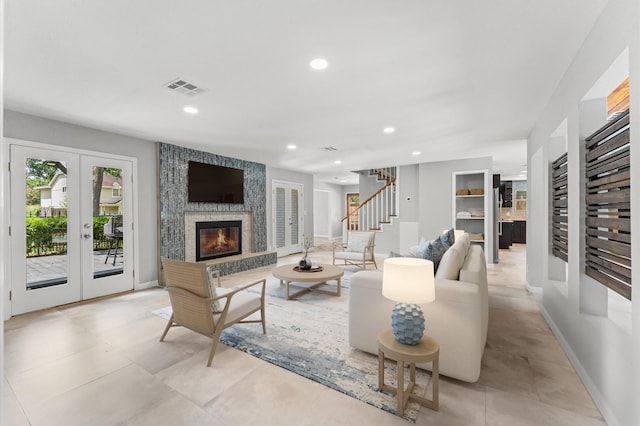 10714 Deerwood Rd, Houston, TX 77042 - living room with stairs, recessed lighting, french doors, and a large fireplace