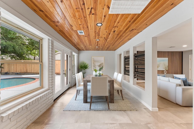 10714 Deerwood Rd, Houston, TX 77042 - dining space with wooden ceiling, recessed lighting, light tile patterned floors, and french doors