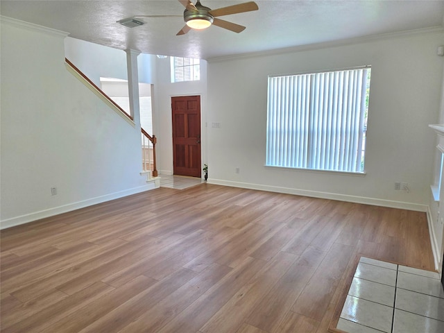 3307 Twelve Oaks Ln, Missouri City, TX 77459 - unfurnished living room featuring wood finished floors, ceiling fan, stairs, and crown molding