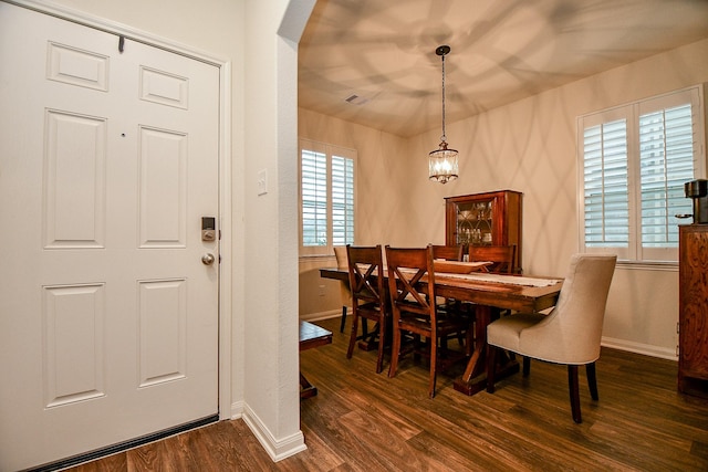 980 Lake View Cir W, Brookshire, TX 77423 - dining room featuring baseboards, dark wood-type flooring, a chandelier, and arched walkways