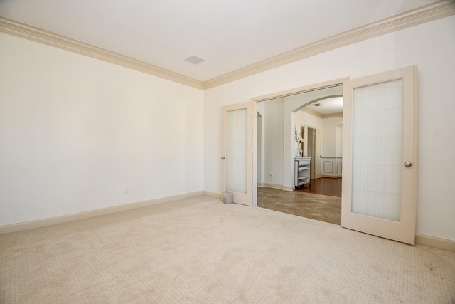 19707 Mission Pines Ln, Richmond, TX 77407 - carpeted empty room with ornamental molding, arched walkways, french doors, and baseboards