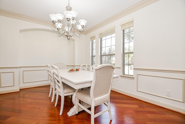 19707 Mission Pines Ln, Richmond, TX 77407 - dining area with ornamental molding, a chandelier, dark wood finished floors, and wainscoting
