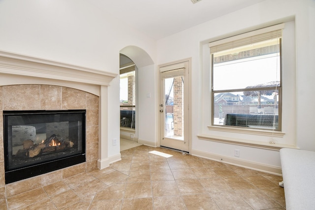 19707 Mission Pines Ln, Richmond, TX 77407 - entryway with a fireplace, baseboards, and arched walkways