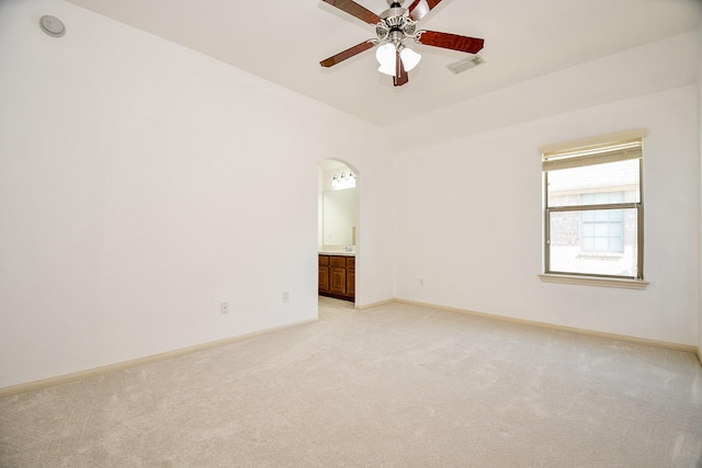 19707 Mission Pines Ln, Richmond, TX 77407 - empty room with light carpet, ceiling fan, arched walkways, and baseboards