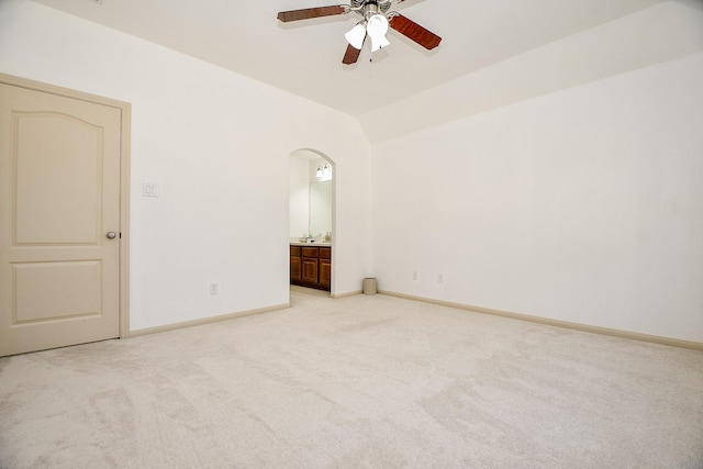 19707 Mission Pines Ln, Richmond, TX 77407 - empty room featuring a ceiling fan, light carpet, arched walkways, baseboards, and lofted ceiling