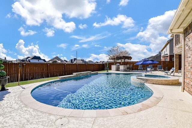 19707 Mission Pines Ln, Richmond, TX 77407 - view of swimming pool with a fenced backyard, a patio, a pool with connected hot tub, and a residential view