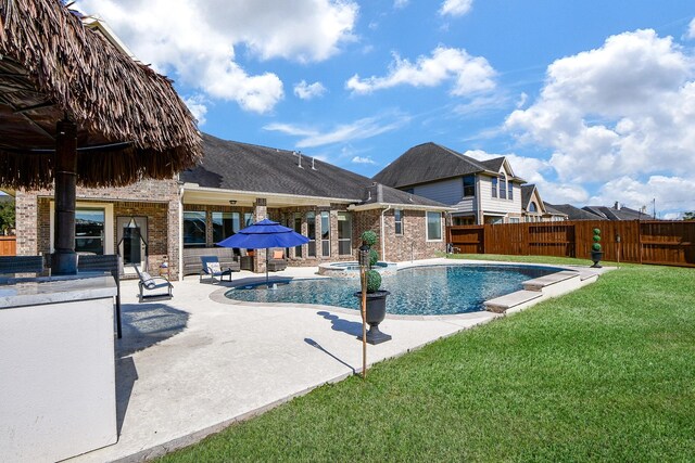 19707 Mission Pines Ln, Richmond, TX 77407 - view of swimming pool with a pool with connected hot tub and a patio