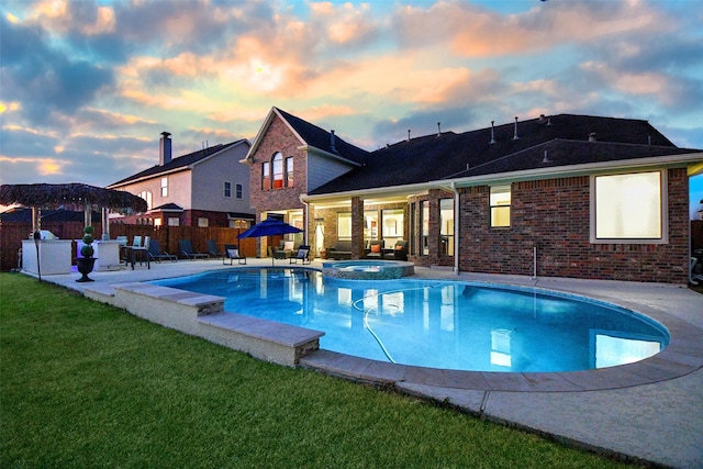 19707 Mission Pines Ln, Richmond, TX 77407 - pool at dusk with a patio area and a pool with connected hot tub