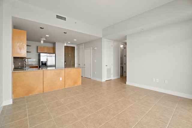 500 Seawall Blvd Unit 1104, Galveston, TX 77550 - kitchen featuring stainless steel fridge, recessed lighting, a peninsula, light tile patterned floors, and decorative light fixtures
