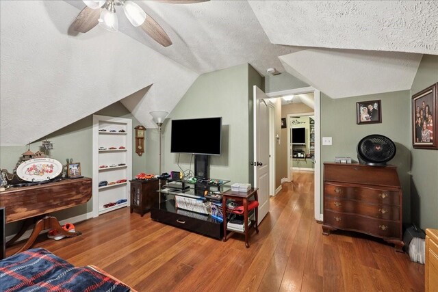 4810 Majestic Dr, Baytown, TX 77523 - bedroom featuring vaulted ceiling, a textured ceiling, wood finished floors, and ceiling fan