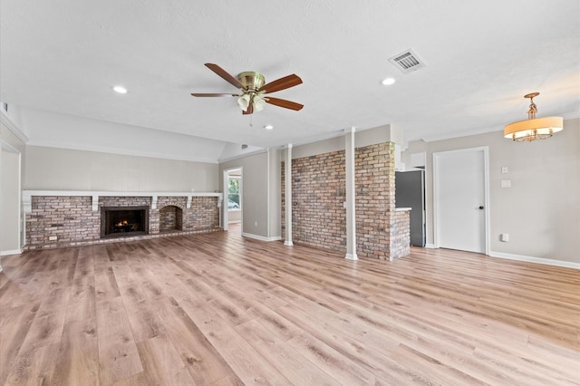 9407 Brooding Oak Cir, Houston, TX 77096 - unfurnished living room with a brick fireplace, ceiling fan, light wood-style floors, brick wall, and baseboards