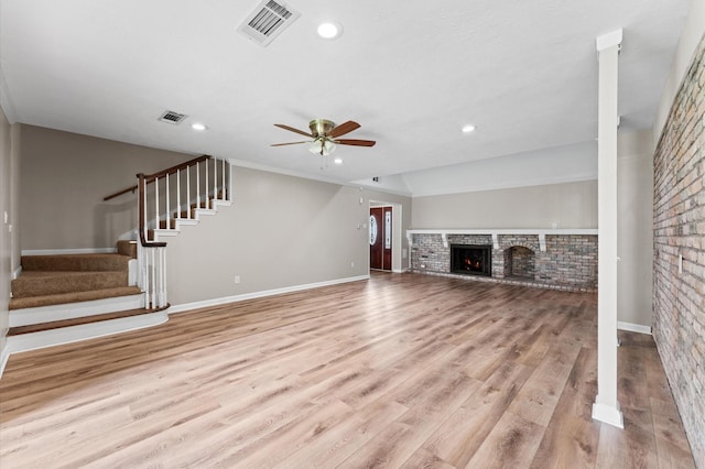 9407 Brooding Oak Cir, Houston, TX 77096 - unfurnished living room with ceiling fan, a fireplace, stairway, wood finished floors, and recessed lighting