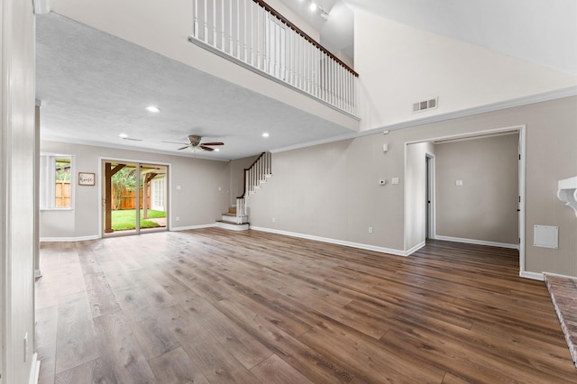 9407 Brooding Oak Cir, Houston, TX 77096 - unfurnished living room featuring ceiling fan, wood finished floors, recessed lighting, baseboards, and stairs