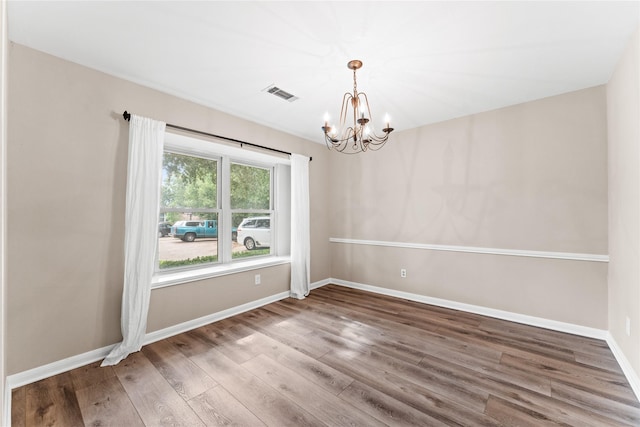 9407 Brooding Oak Cir, Houston, TX 77096 - empty room featuring a chandelier, wood finished floors, and baseboards