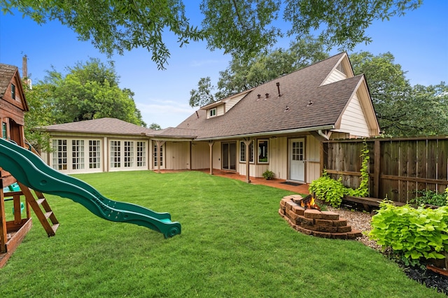 9407 Brooding Oak Cir, Houston, TX 77096 - rear view of house with a playground, board and batten siding, a shingled roof, and french doors