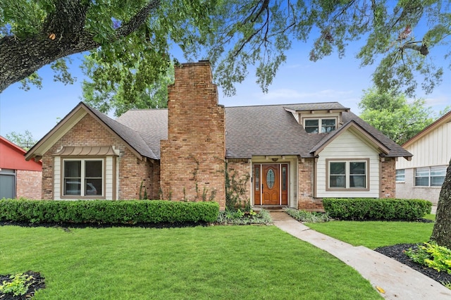 9407 Brooding Oak Cir, Houston, TX 77096 - view of front of home featuring a front yard, a shingled roof, brick siding, and a chimney