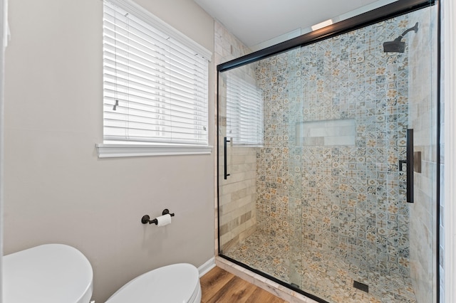 9407 Brooding Oak Cir, Houston, TX 77096 - full bath with toilet, a stall shower, plenty of natural light, and wood finished floors