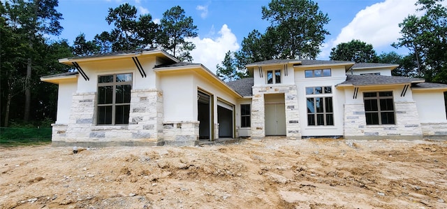 1020 Prescott Dr, Conroe, TX 77301 - prairie-style home with stone siding, stucco siding, and roof with shingles