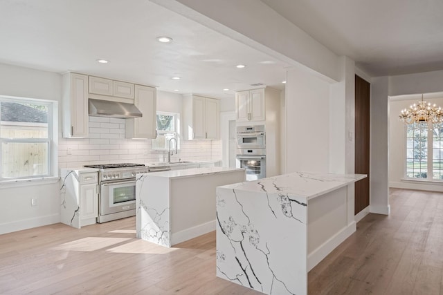 736 Voss Rd, Hunters Creek Village, TX 77024 - kitchen featuring appliances with stainless steel finishes, a kitchen island, range hood, light wood-style floors, and recessed lighting